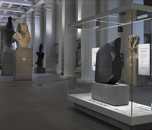 The Rosetta Stone in the British Museum, behind glass display