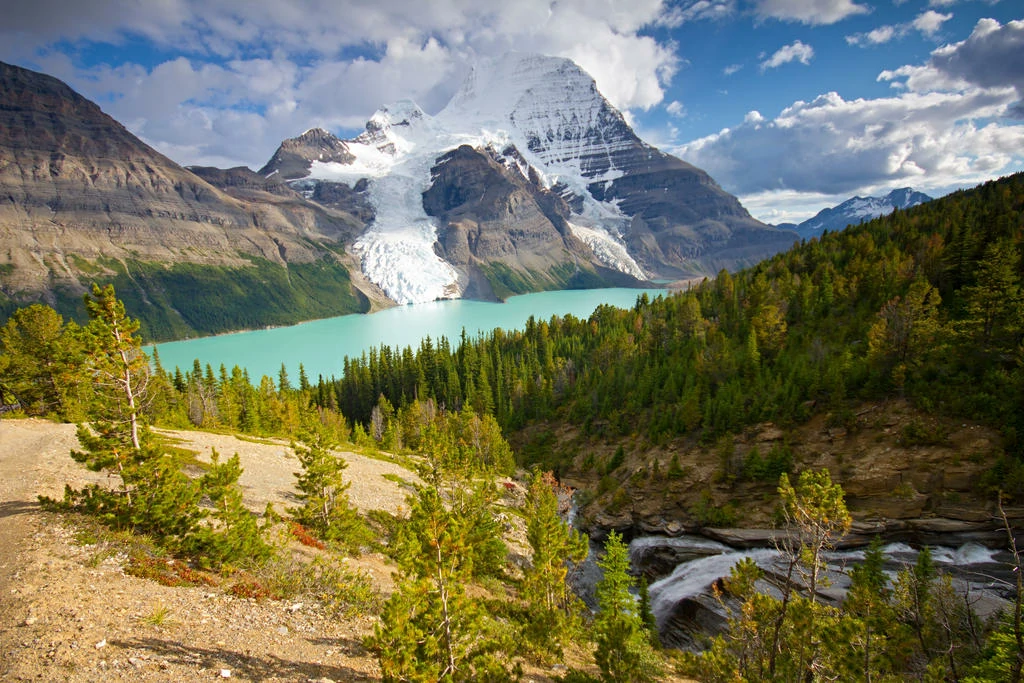 Snow-covered Mount Robson under cloudy sky