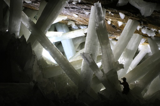 Scientist exploring between massive selenite crystals in Naica