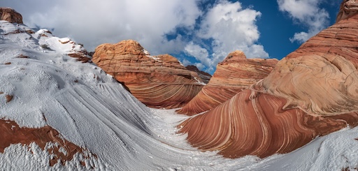 Hikers walking through The Wave’s sandstone curves in Arizona
