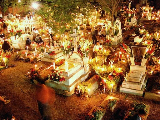 Mixquic cemetery glowing with candles and marigolds at night