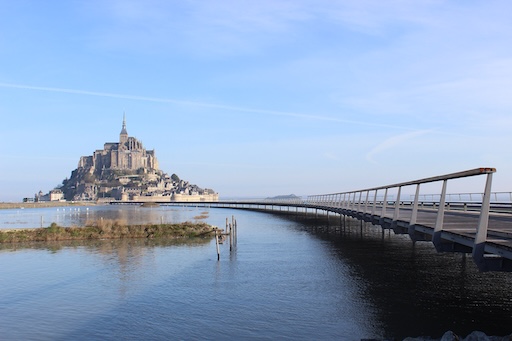 Mont-Saint-Michel village path at sunset, quiet and glowing