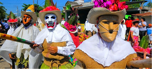 Carnival-goers with red and black paint during festivities