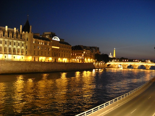 Couple enjoying a sunset Seine river cruise with Eiffel Tower in view