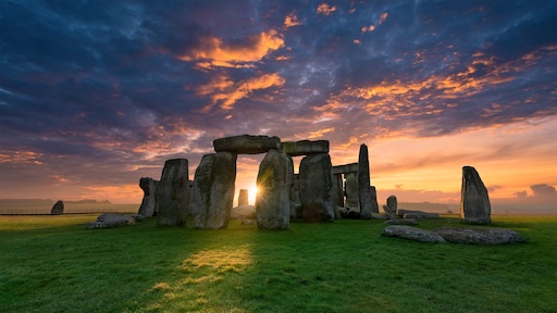 Stonehenge viewed from the side under a blue sky