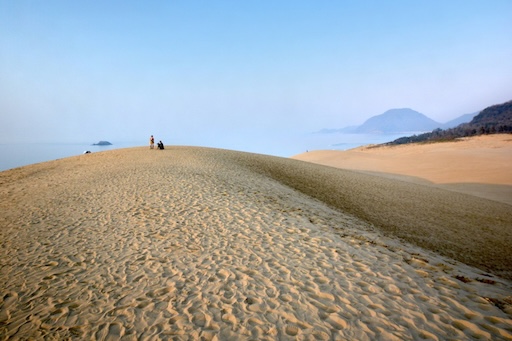 Vast view of Tottori Sand Dunes under blue sky