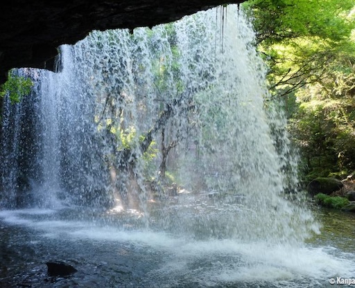 Sunlight through mist at Nabegataki Waterfall